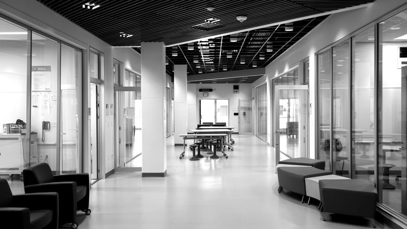 An empty school hallway, in black and white